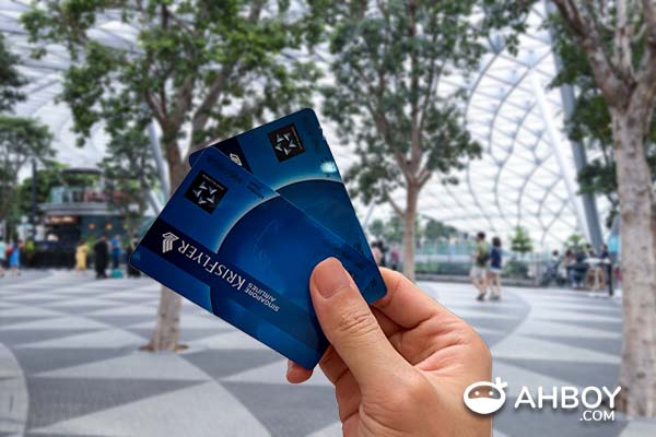 How to redeem Krisflyer miles for flights - Krisflyer membership cards with Jewel Changi Airport in the background